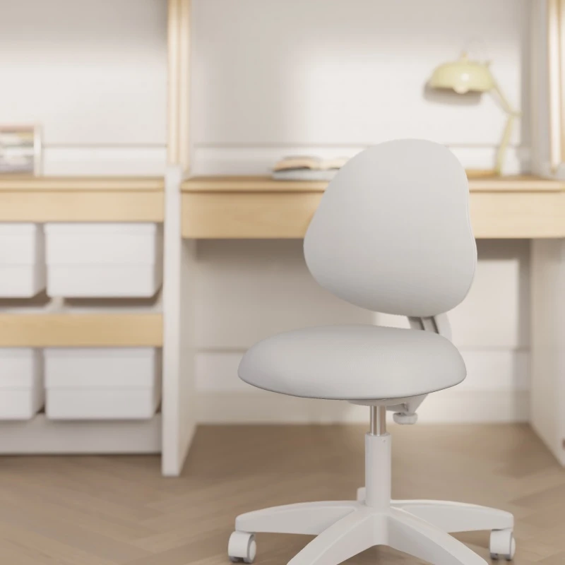 Grey ergonomic swivel chair with a curved, contoured backrest, shown against a blurred desk backdrop Grey ergonomic swivel chair with a curved, contoured backrest, shown against a blurred desk backdrop